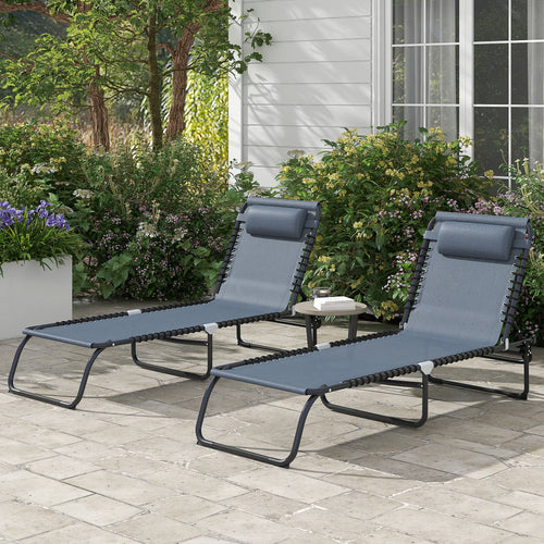 Two gray folding chaise lounge pool chairs with adjustable reclining backs and pillows on patio