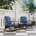 gray rattan chaise lounge chairs with blue cushions and wicker side table on patio