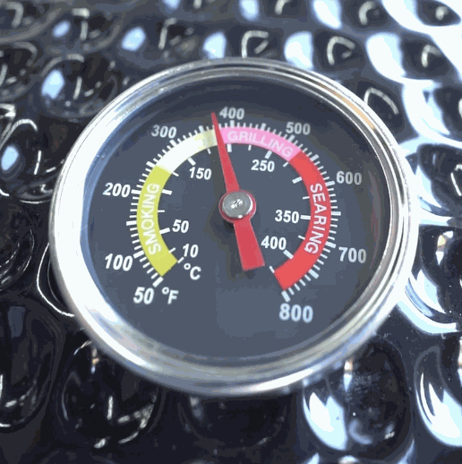 Close-up of temperature gauge on 21 Inch Charcoal Kamado ceramic BBQ grill showing grilling and searing heat zones
