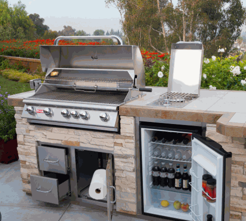 Brahma 38" 5-burner stainless steel grill with heavy duty cart, side burner, double door storage, and built-in refrigerator in outdoor kitchen setting