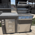Kokomo Grills 5' BBQ Island with 3-burner stainless steel grill and triple storage drawers in a compact outdoor cooking station.