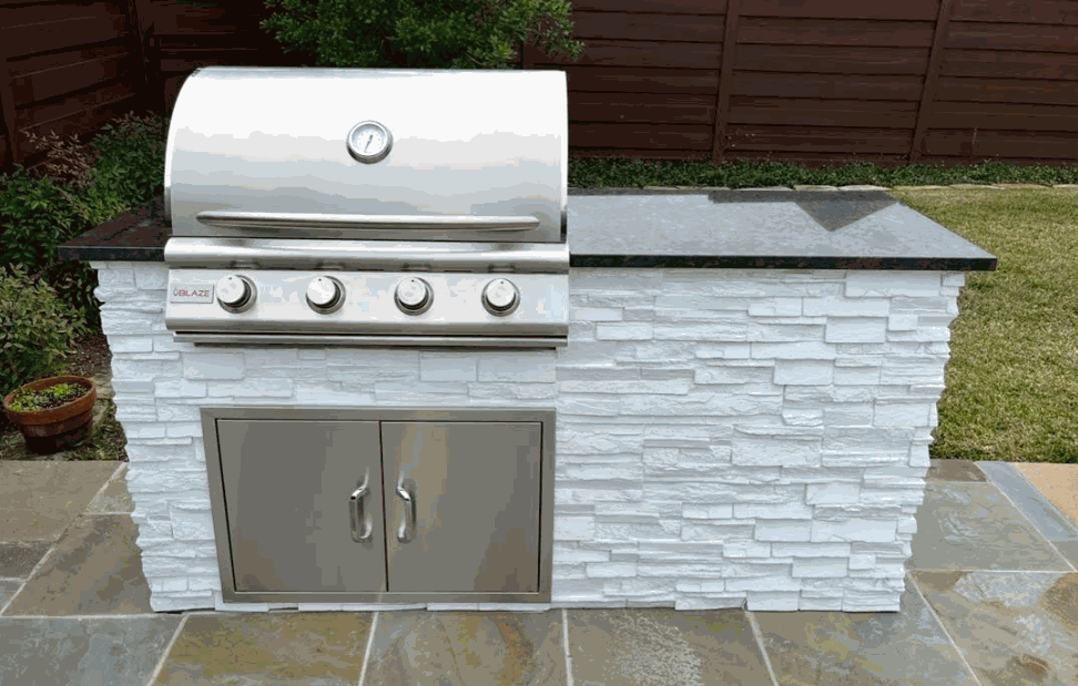 5-foot outdoor kitchen deluxe island with Blaze three burner LBM grill, stainless steel double doors, white textured stone finish, and black granite countertop