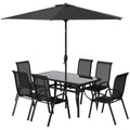 Black 8-piece patio furniture set with dining table, six chairs, and 9ft adjustable umbrella
