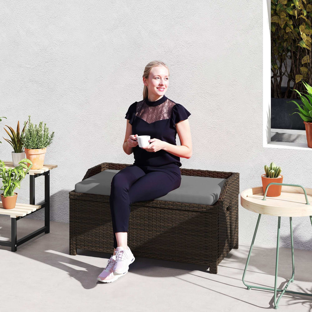 Gray cushioned outdoor wicker storage bench with hidden compartment and dark brown rattan design